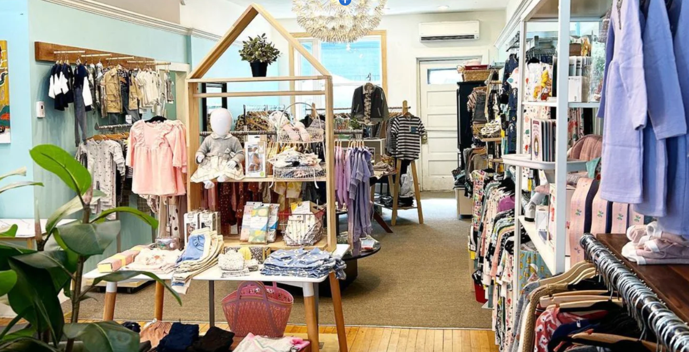 A PHOTO OF THE INSIDE OF TEENY BEE BOUTIQUE VIEWED FROM THE FRONT WINDOW.