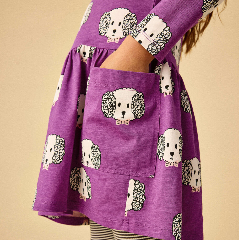 Purple dress with dog pattern on a beige background