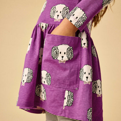 Purple dress with dog pattern on a beige background
