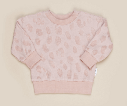 a pink sweatshirt with soft animal print texture