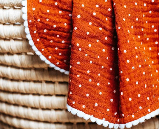 Orange polka dot pompom baby blanket